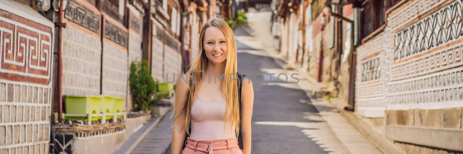 Young woman tourist in Bukchon Hanok Village is one of the famous place for Korean traditional houses have been preserved. Travel to Korea Concept. BANNER, LONG FORMAT