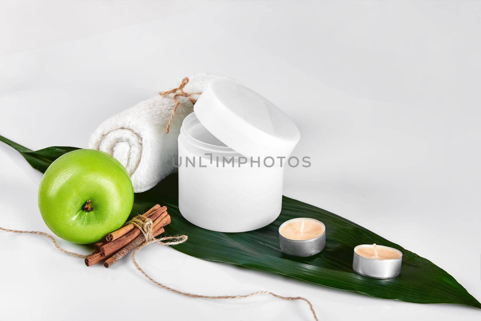Natural spa beauty treatment cleansing products with apple on white background. The concept for advertising cosmetics. Still life. Copy space
