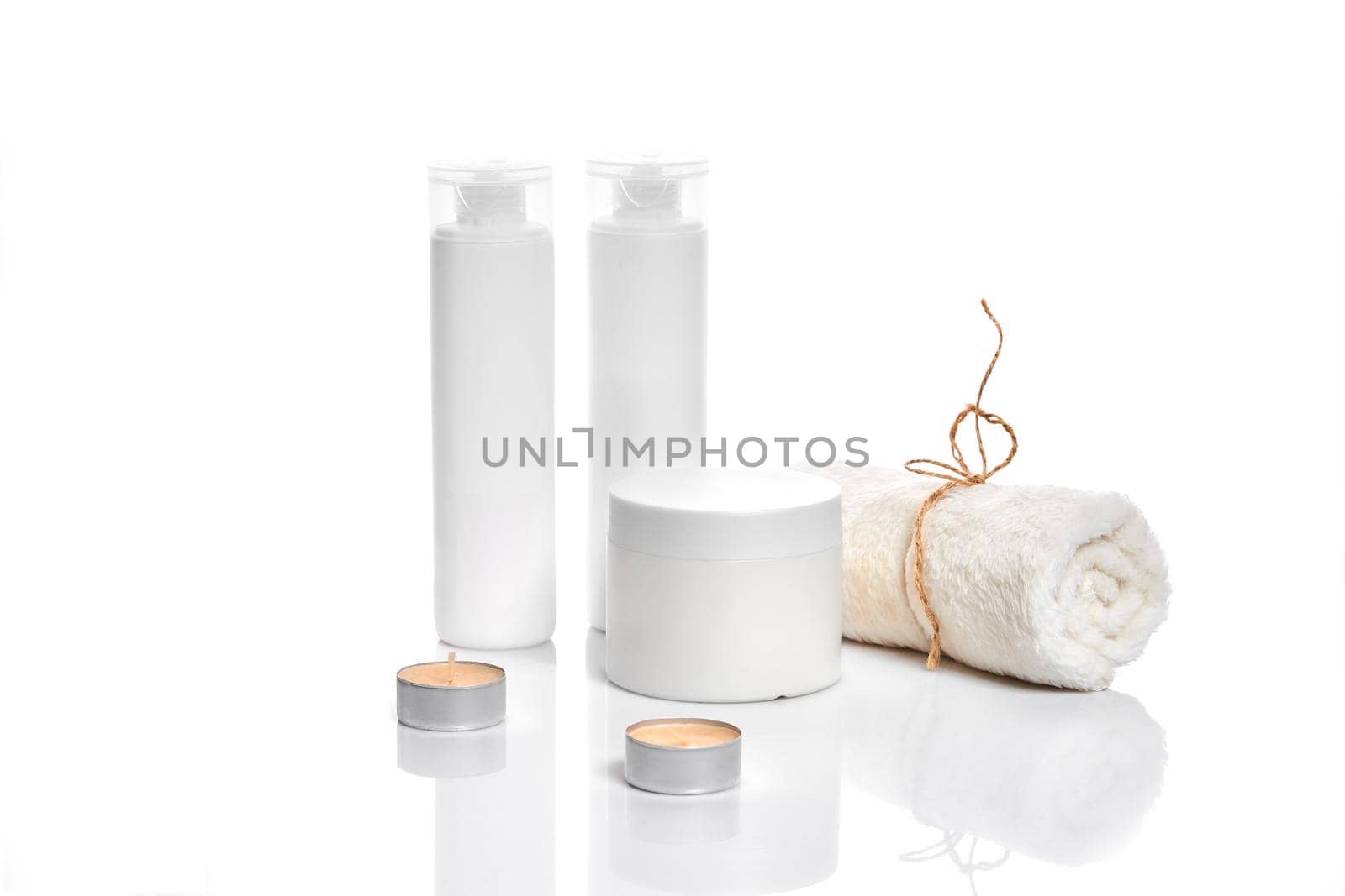 Set of cosmetic products in white containers on light background. Still life. Copy space. Place for your brand