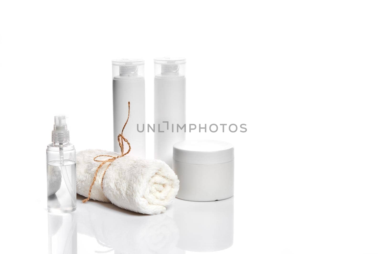 Set of cosmetic products in white containers on light background. Still life. Copy space. Place for your brand