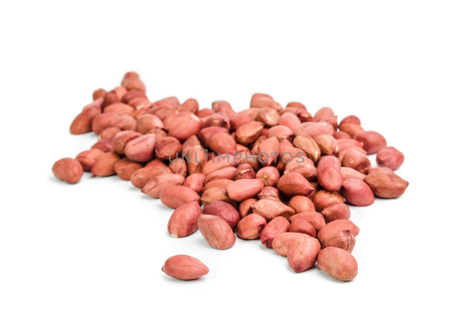 Dried peanuts in closeup on white background.