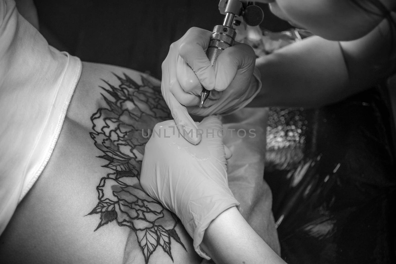 Professional tattoo artist demonstrates the process of getting tattoo.