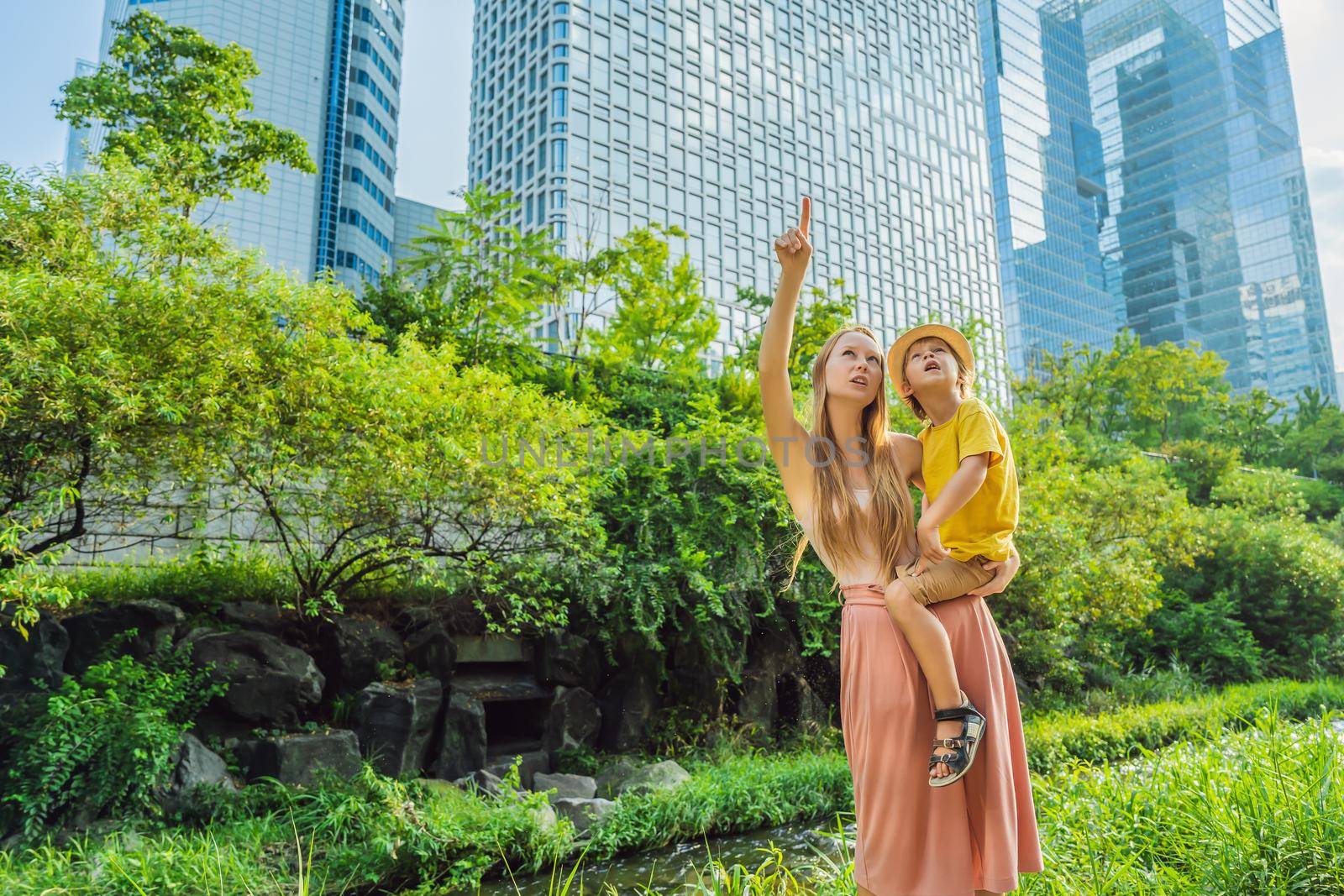 Mom and son tourists in Cheonggyecheon stream in Seoul, Korea. Cheonggyecheon stream is the result of a massive urban renewal project. Travel to Korea Concept by galitskaya