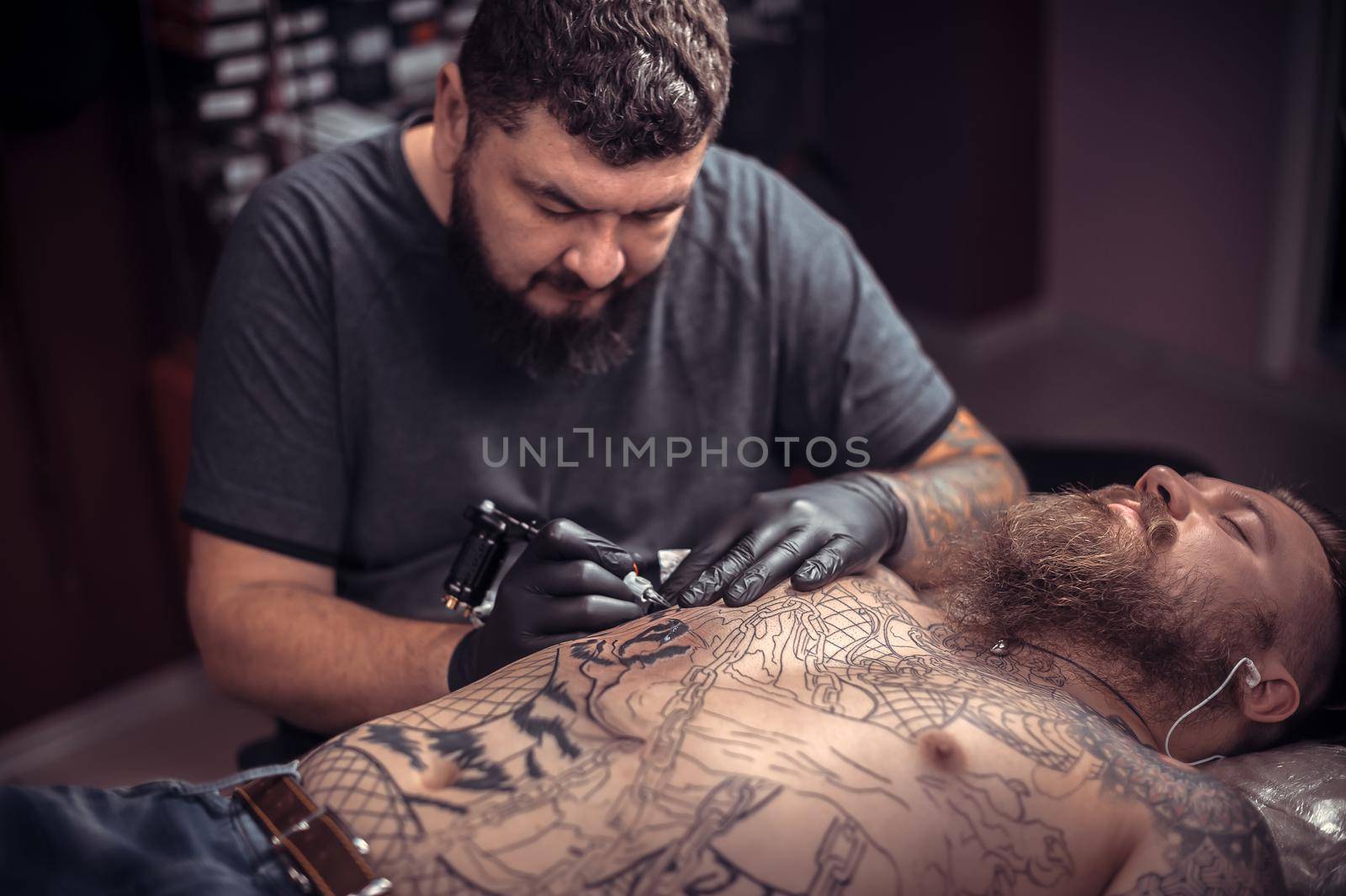 Tattooer making tattoo in salon tattoo studio by Proff