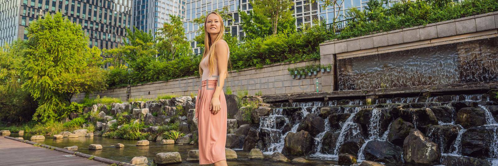 Young woman tourist in Cheonggyecheon stream in Seoul, Korea. Cheonggyecheon stream is the result of a massive urban renewal project. Travel to Korea Concept BANNER, LONG FORMAT by galitskaya