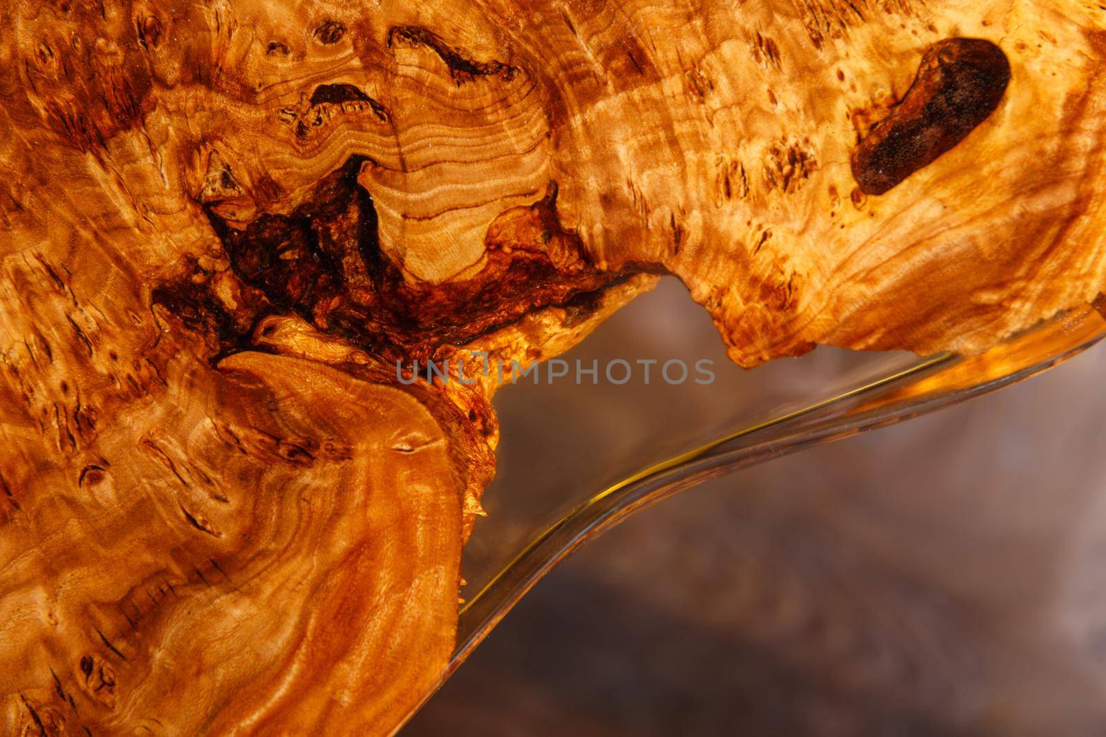 The edge of wooden stylish table made of solid walnut with epoxy resin in stylish interior