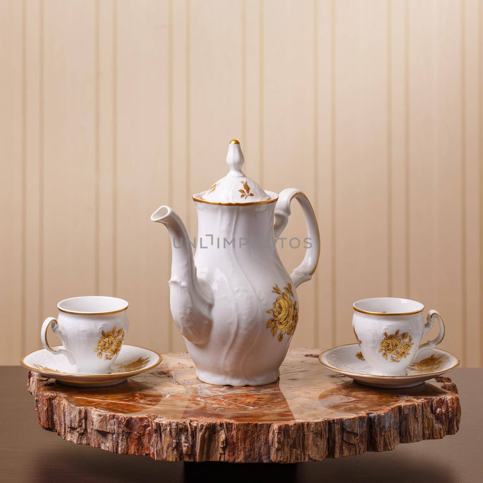 Elegant coffee set on an exclusive tray made from a cut of ancient petrified wood