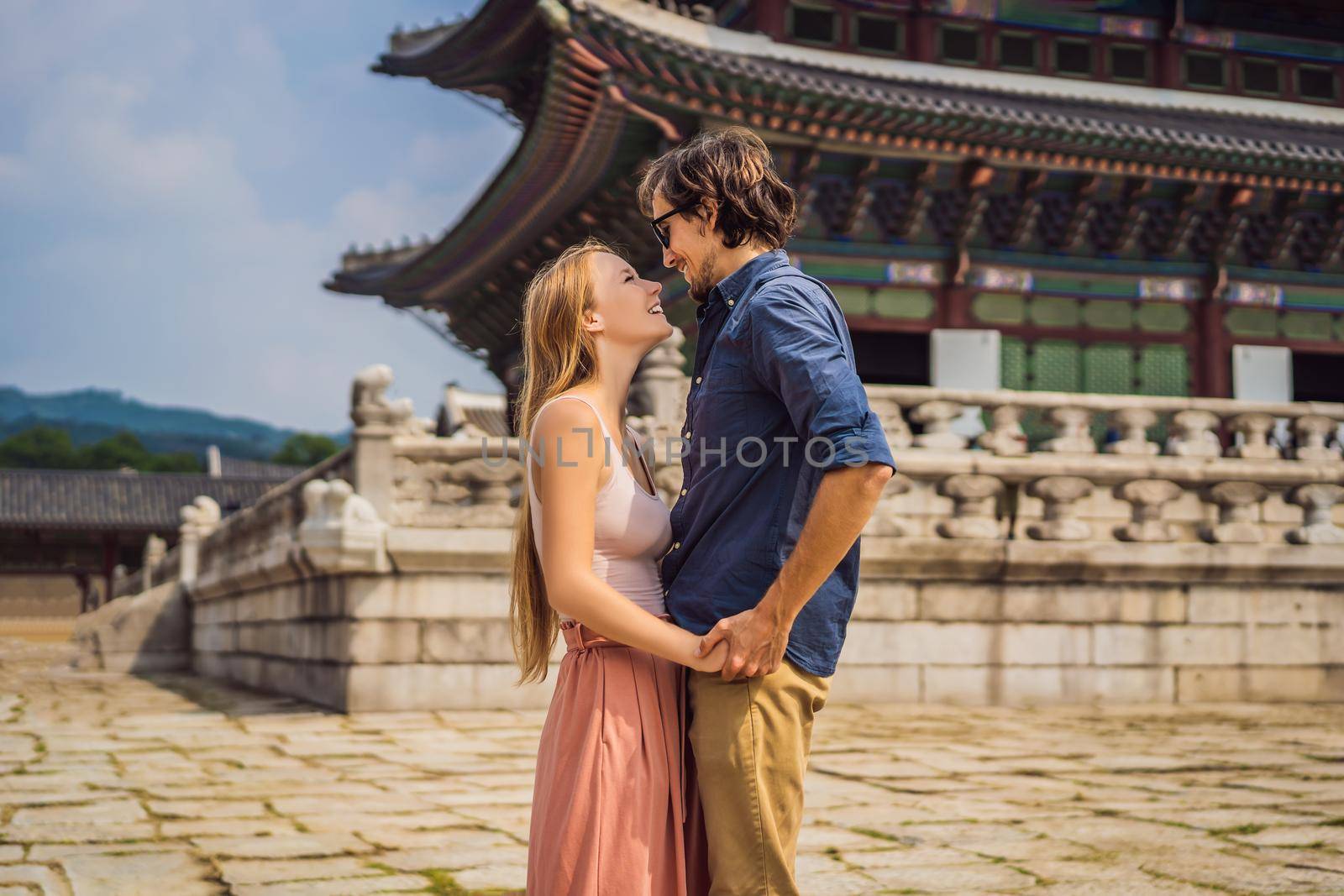 Young couple of spouses, a bride and groom, a husband and wife, boyfriend and girlfriend spend time in Korea. Holidays in Korea. Honeymoon, travel to Korea concept.