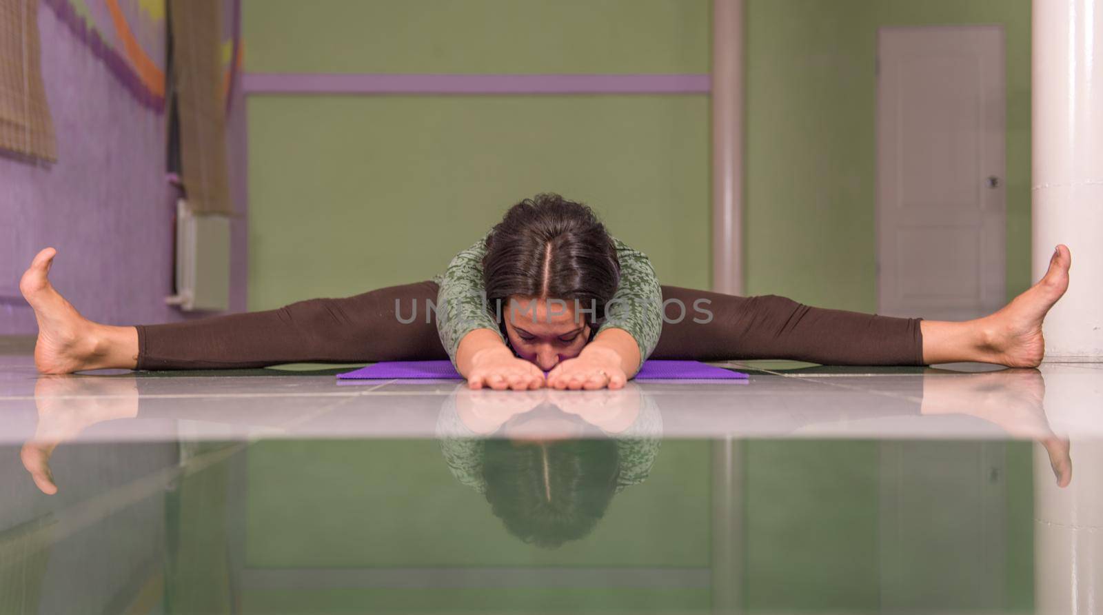 Yoga trainee performing yoga poses in the gym by Proff