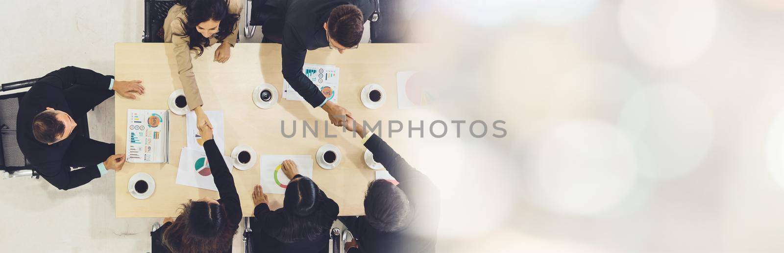 Group business people handshake at meeting table broaden view by biancoblue