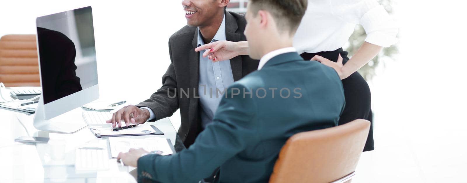 business team discussing work problems sitting at their Desk in the office