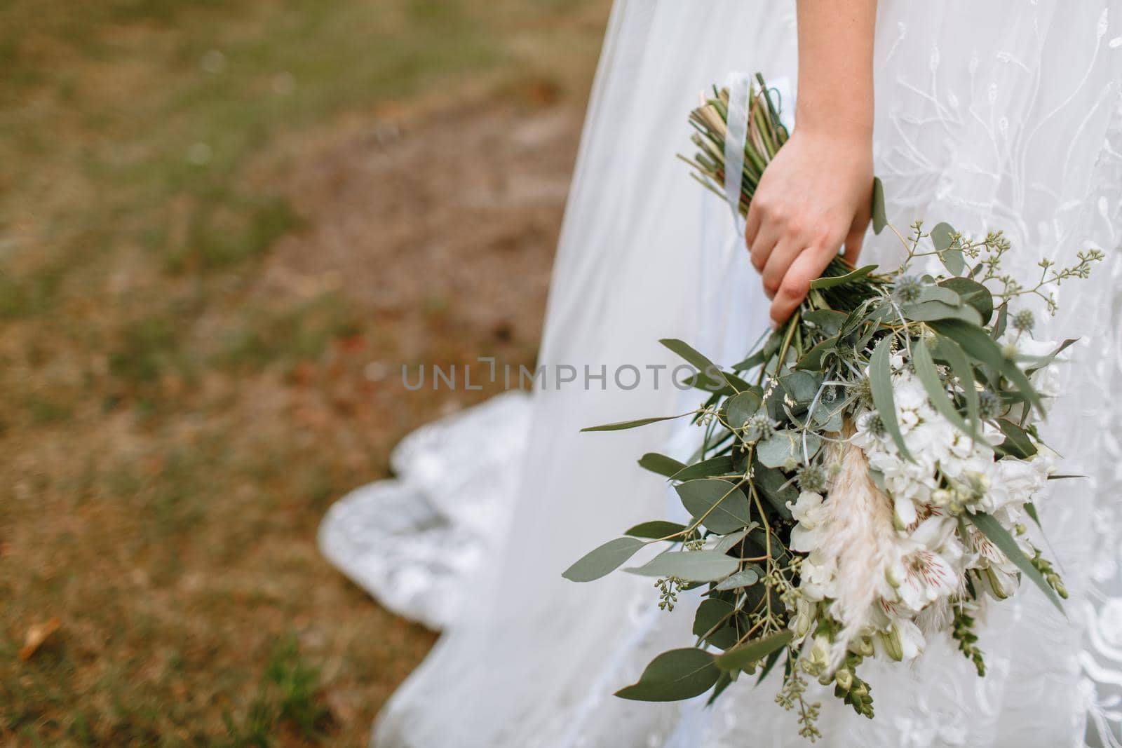 beautiful wedding bouquet in the hands of the bride. The bride holds a bouquet by deandy