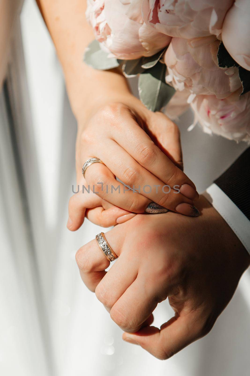 The hands of the newlyweds, which wearing wedding ring by deandy