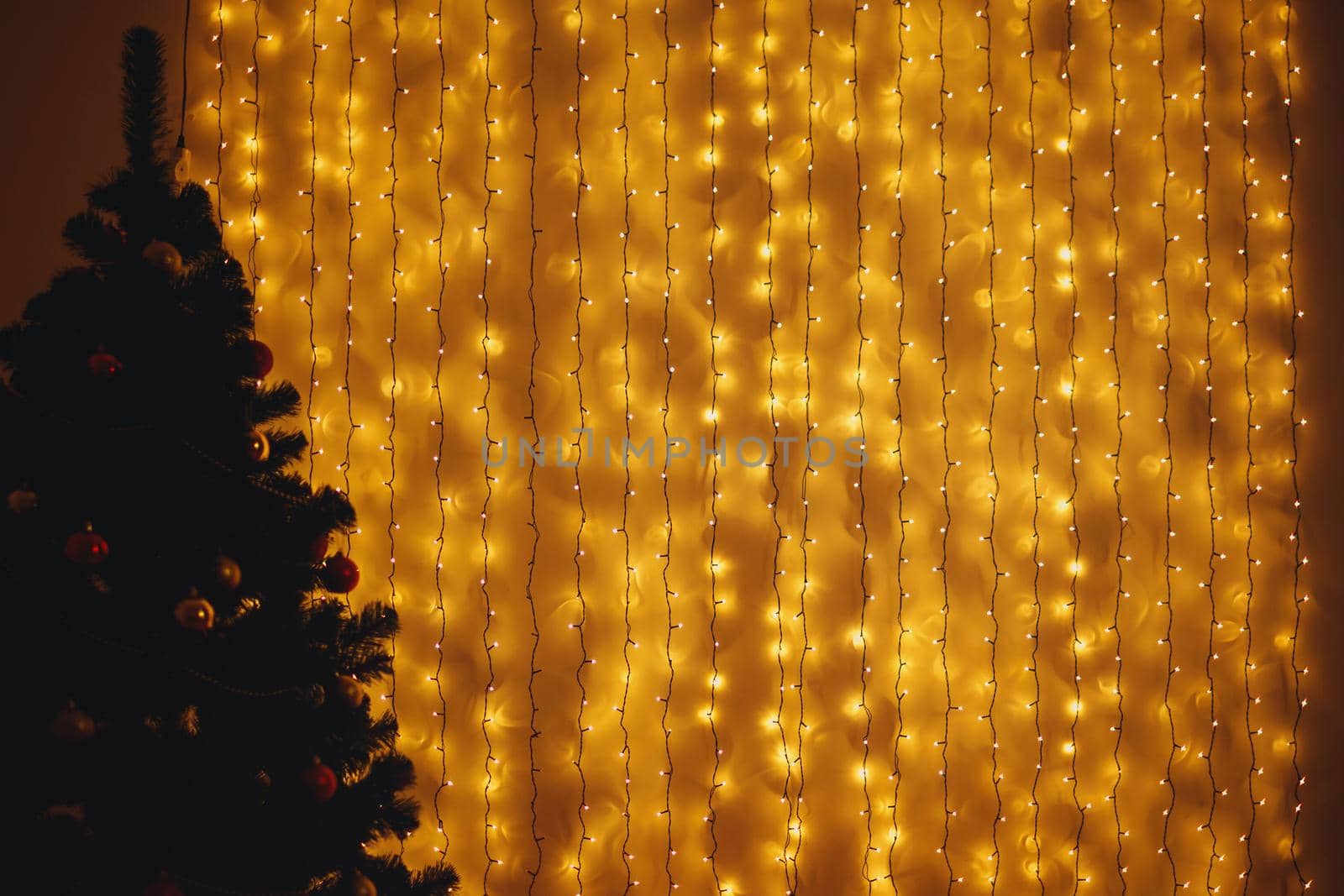Lighted Christmas garland hanging on the wall