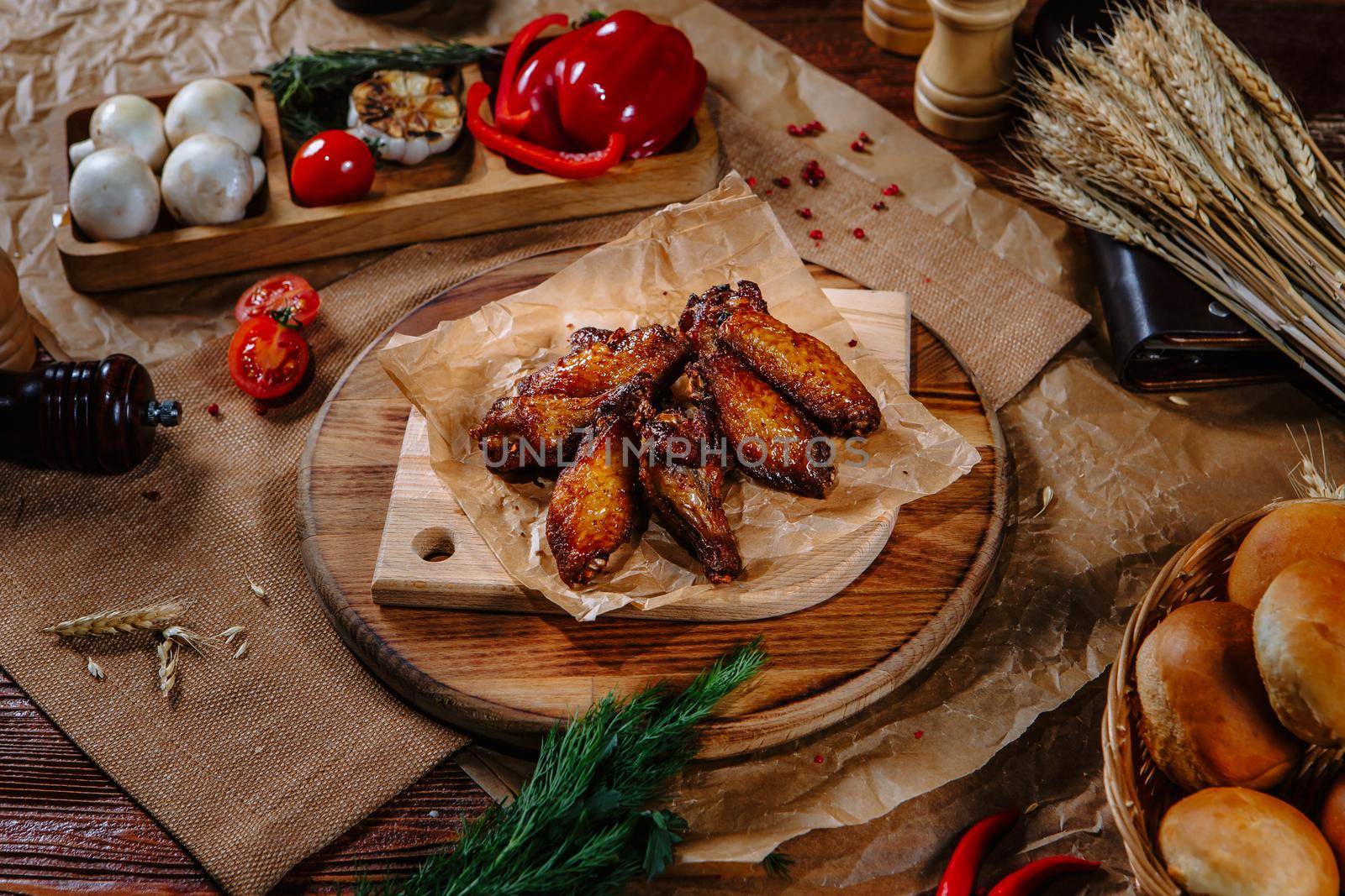 Fried chicken wings lying on craft paper. by deandy