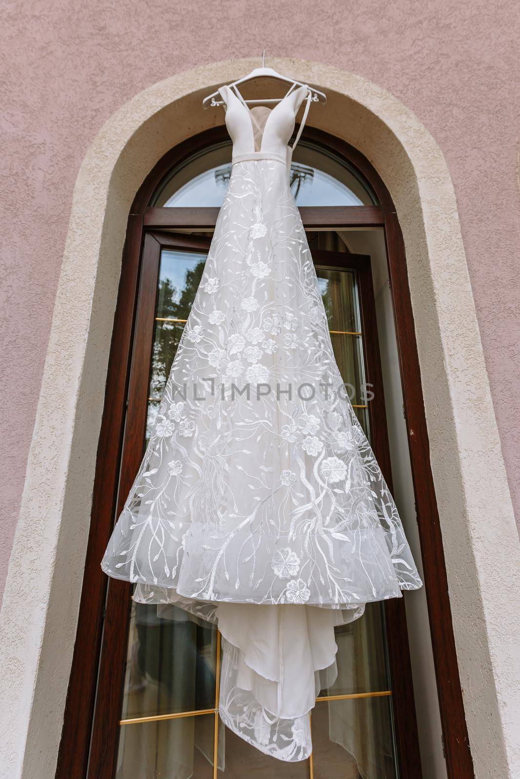 Hanging white wedding dress on the balcony.
