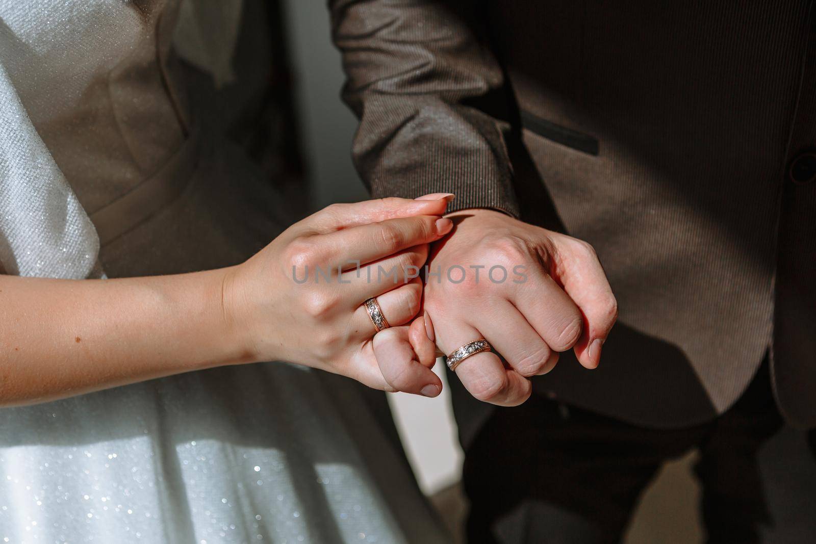 The hands of the newlyweds, which wearing wedding ring by deandy