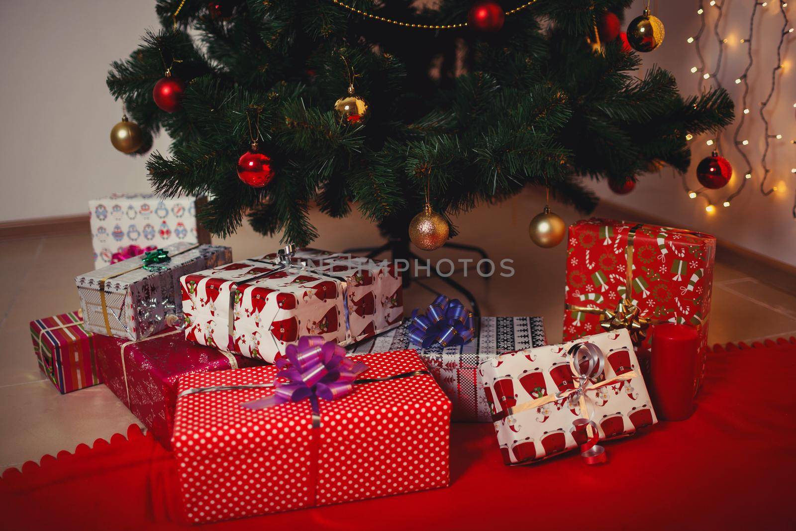 Christmas tree with Christmas toys. Gifts lying under the tree by deandy