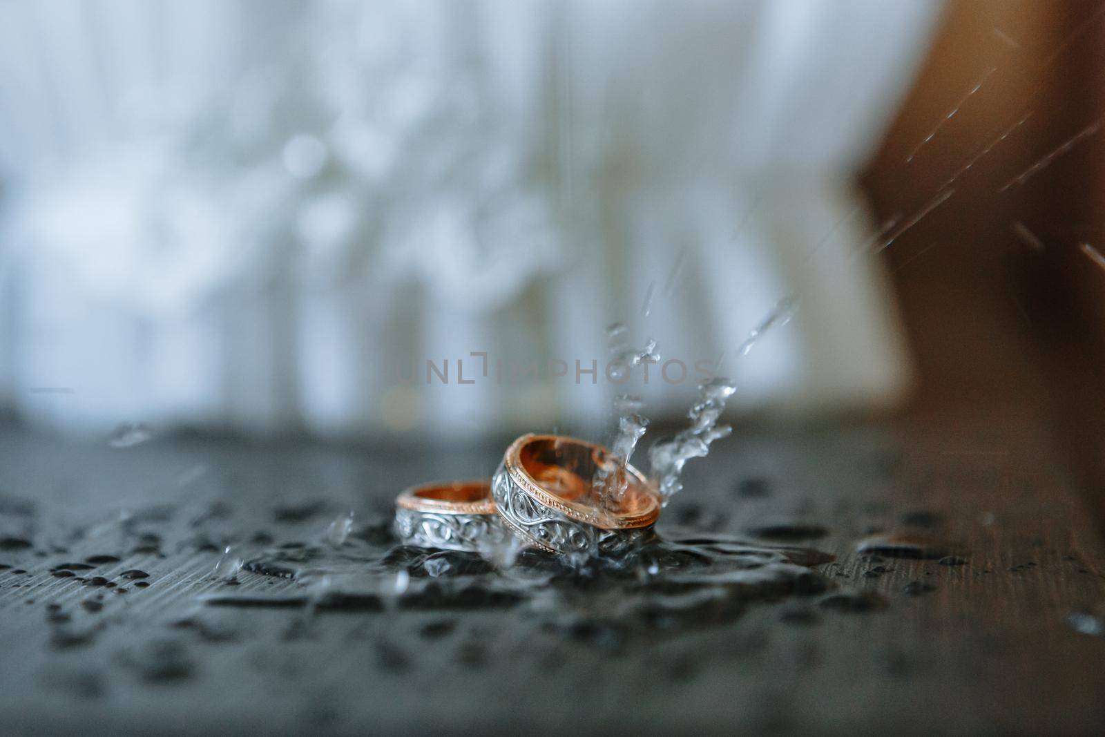 Wedding rings with water drops falling on them by deandy