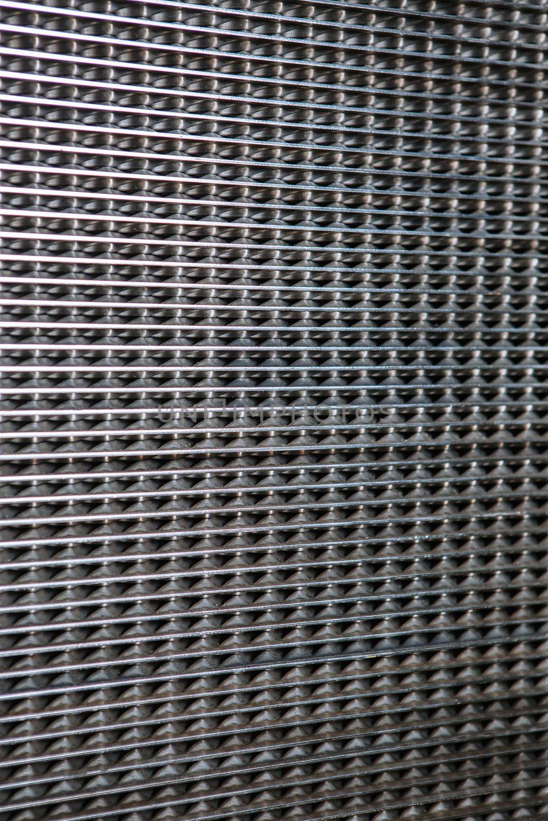 A metal heat exchanger grid consisting of small cells. Pattern by deandy