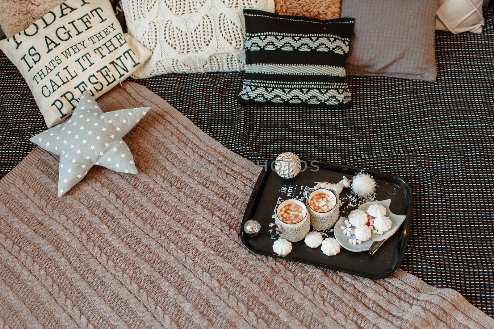 Coffee with marshmallows on a tray on the bed by deandy