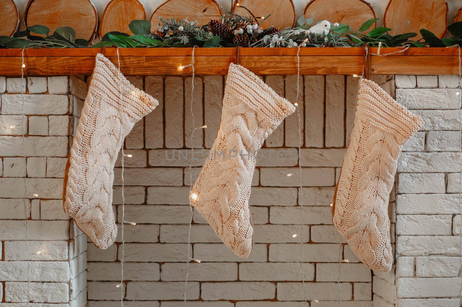 White Christmas gift socks hanging on the mantel by deandy