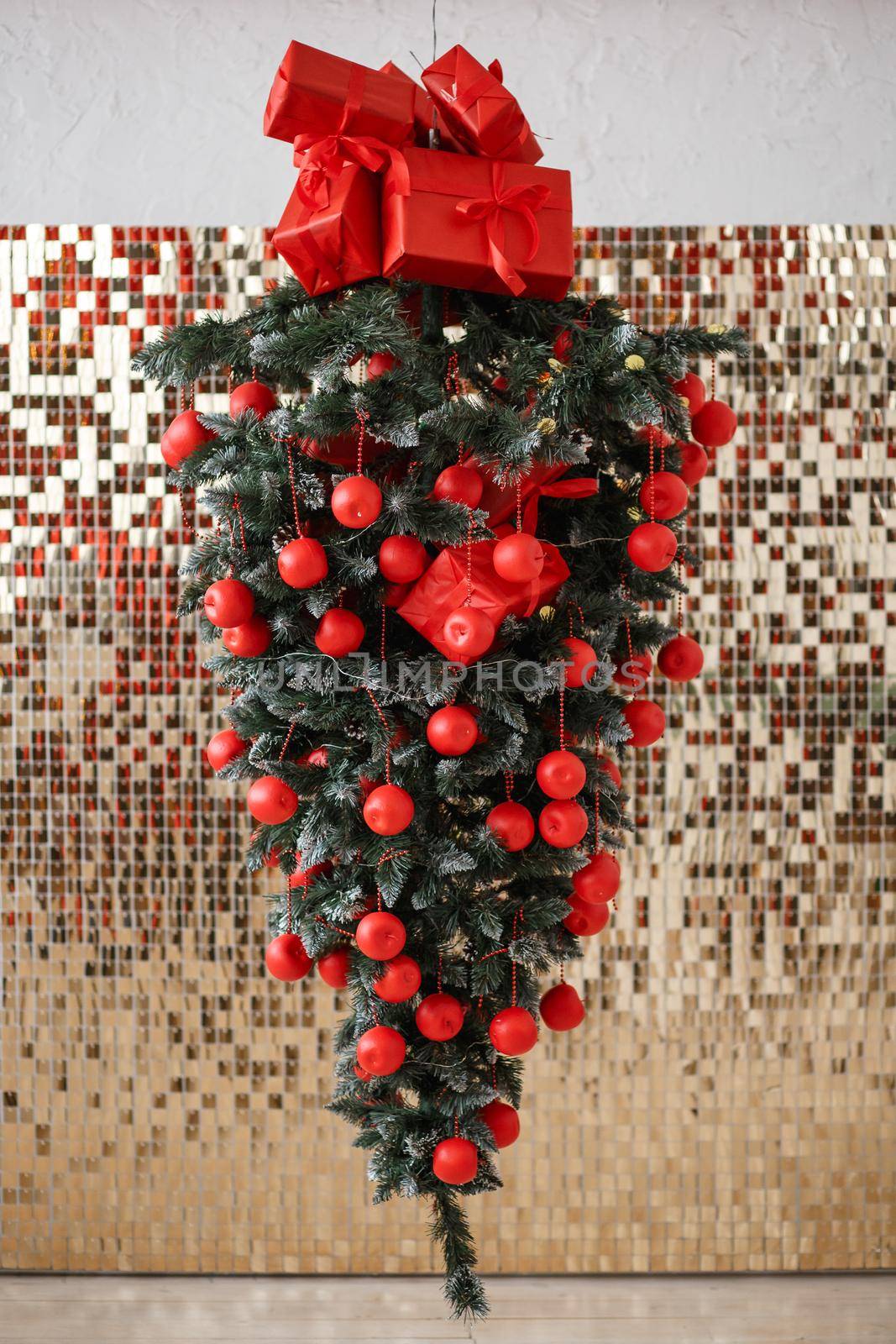 An inverted Christmas tree hanging in the air Art object.