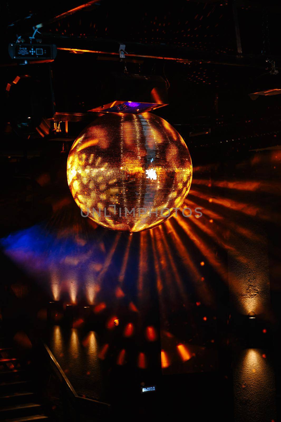 Disco ball hanging on the ceiling of the disco Rays of light are reflected from it by deandy