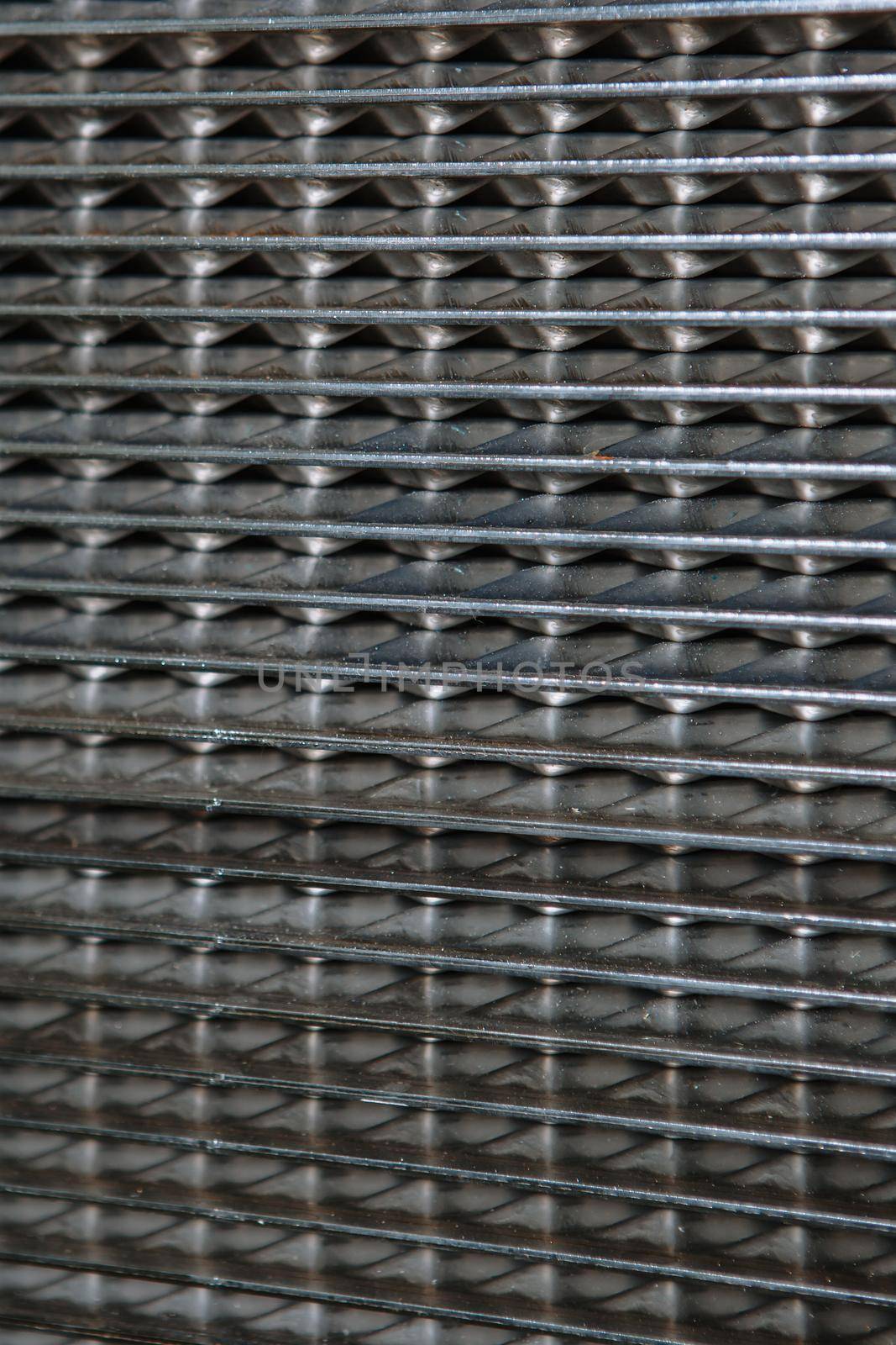 A metal heat exchanger grid consisting of small cells. Pattern