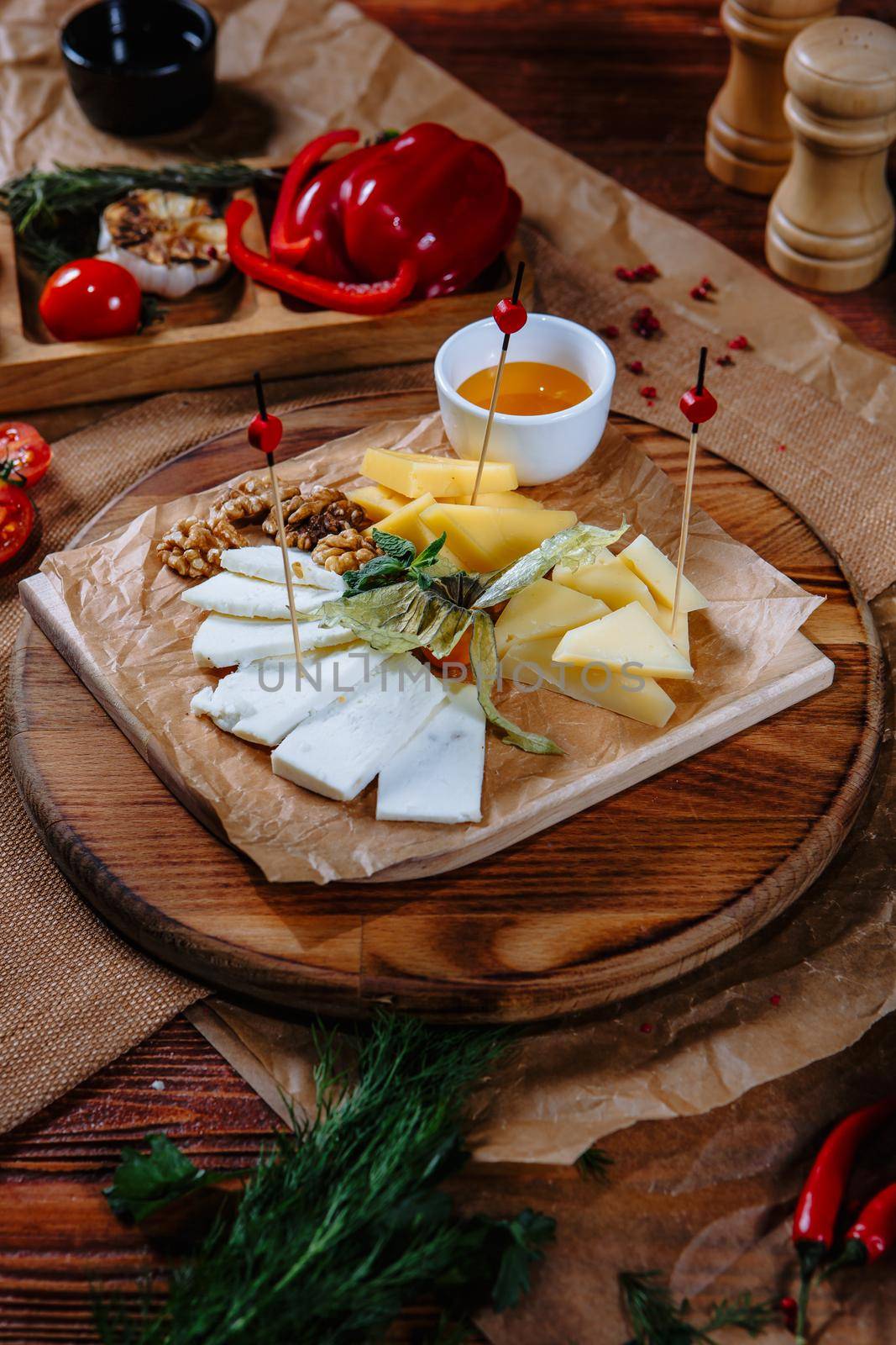 cheese plate with nuts and honey.