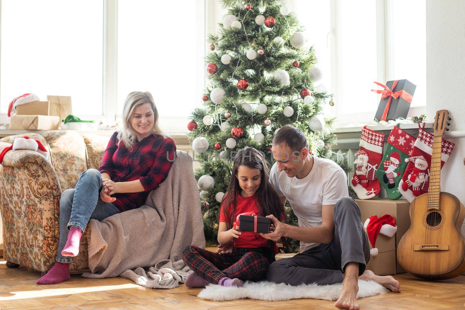 Family decorating a Christmas tree by Andelov13