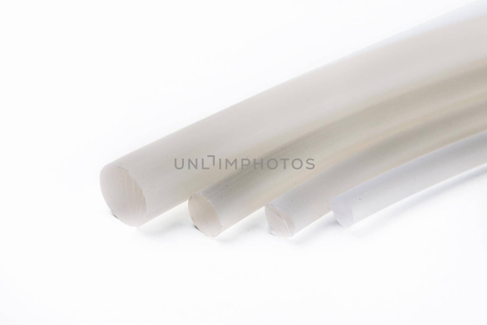 Tips of rubber hoses of different diameters, on a white background.