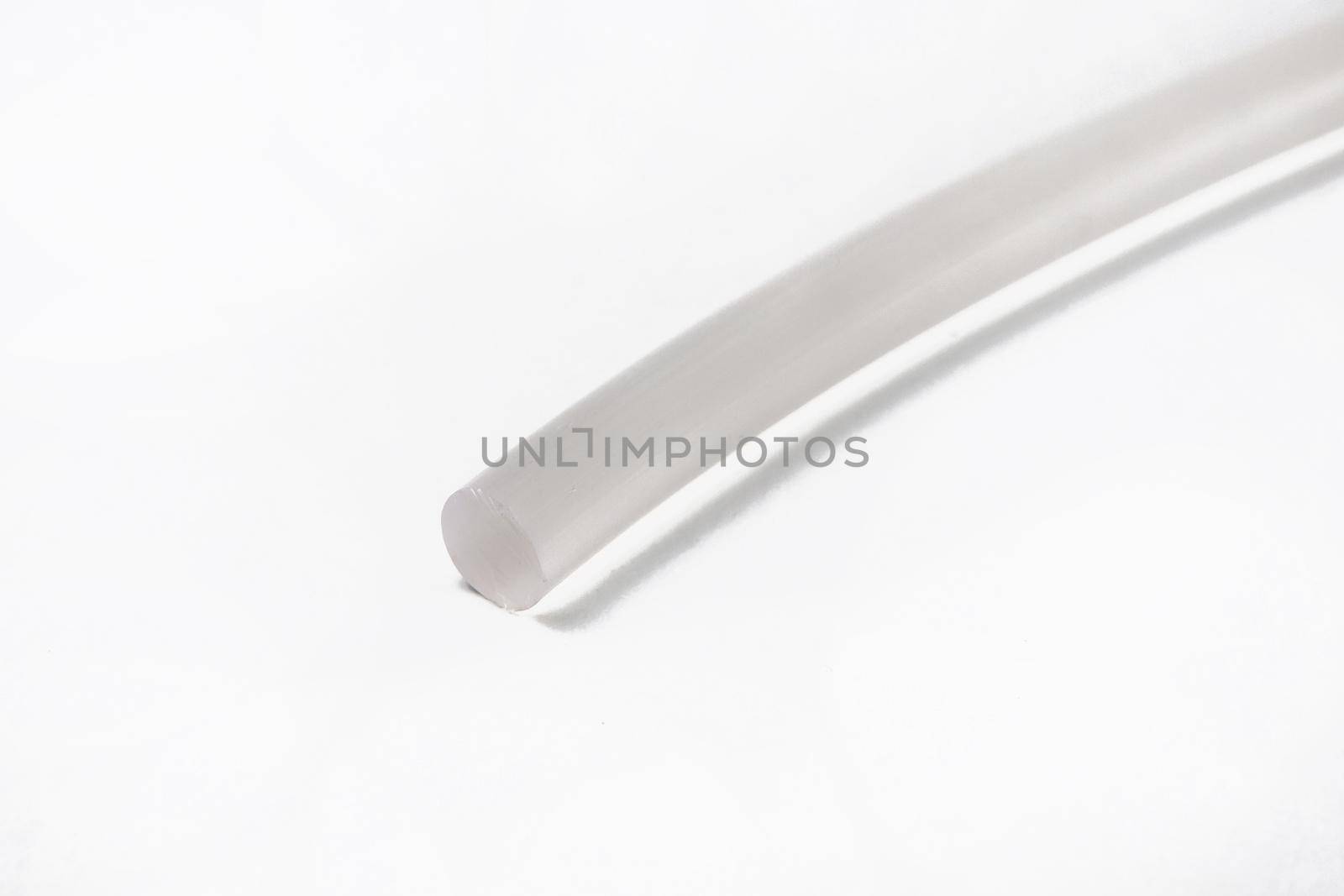 The cut tip of the rubber hose, on a white background by deandy