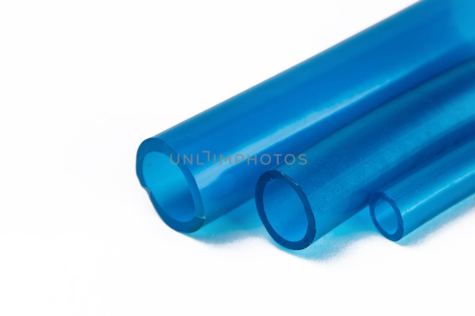Tips of rubber hoses of different diameters, on a white background.