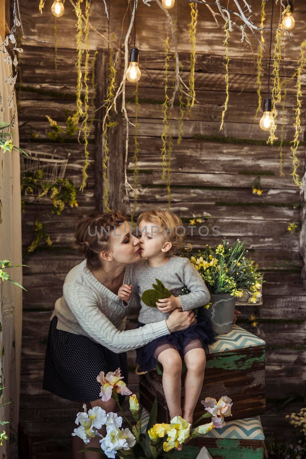 happy mother and little daughter on the background of country house