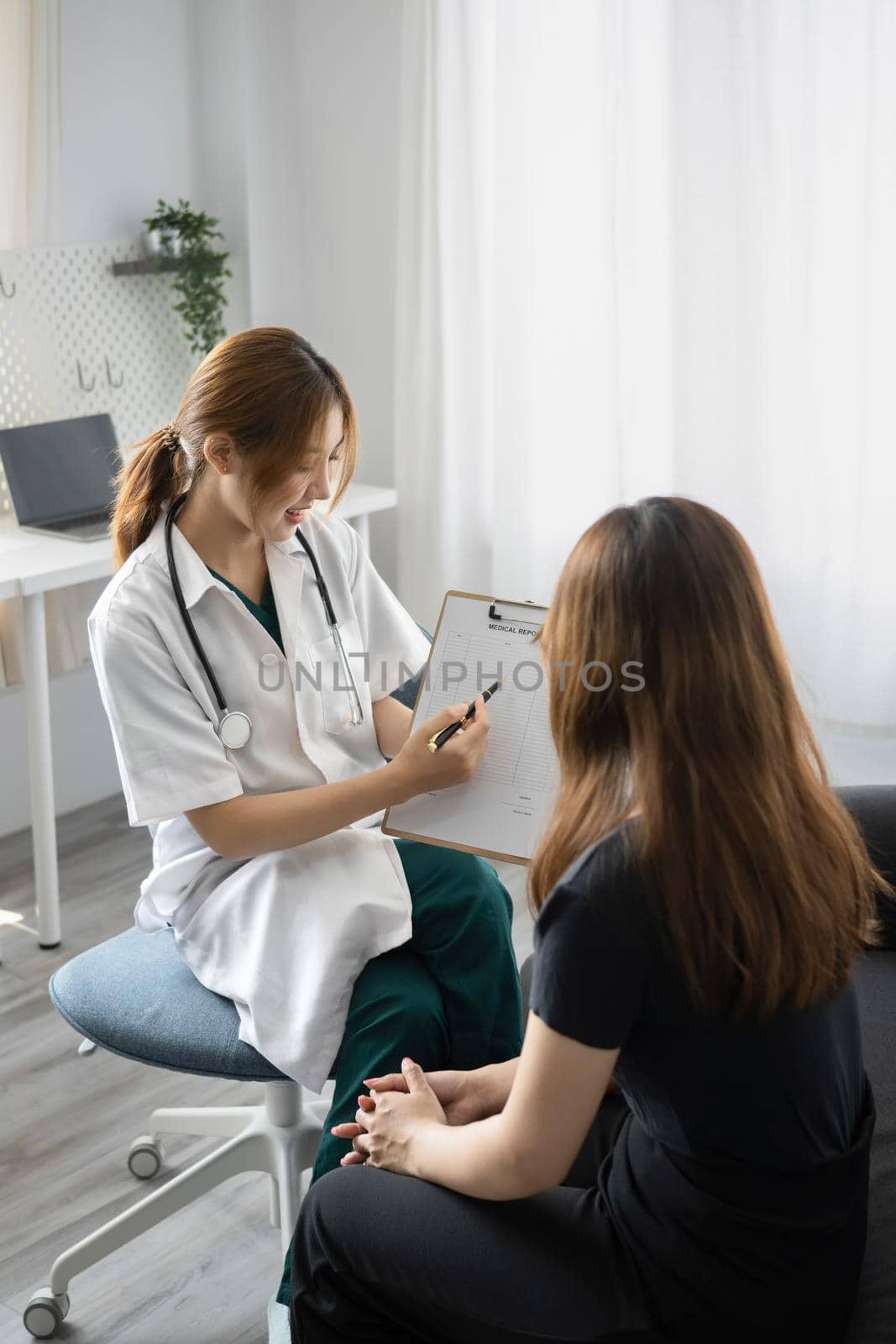 Female doctor explaining diagnosis to her patient. Healthcare and medical concept.