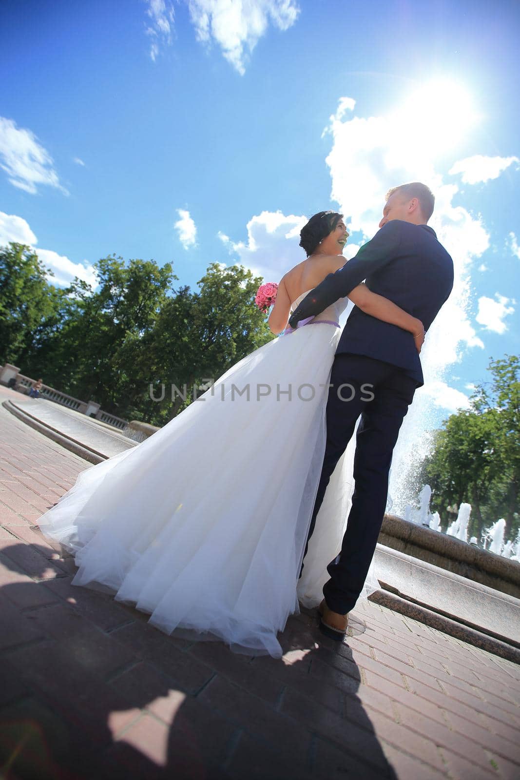 happy couple standing in the town square the day of the wedding. photo with copy space