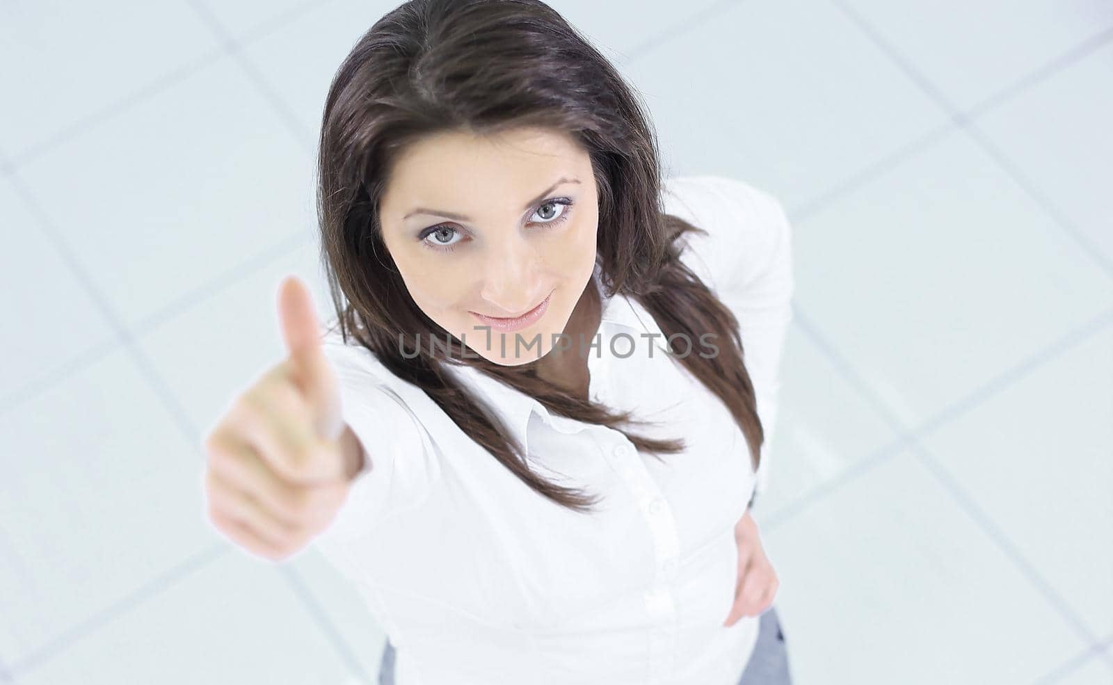 view from the top.in full growth.successful business woman showing thumb up by SmartPhotoLab