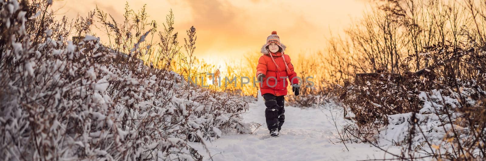 Cute boy in red winter clothes runs fun in the snow. Winter Fun Outdoor Concepts BANNER, LONG FORMAT by galitskaya