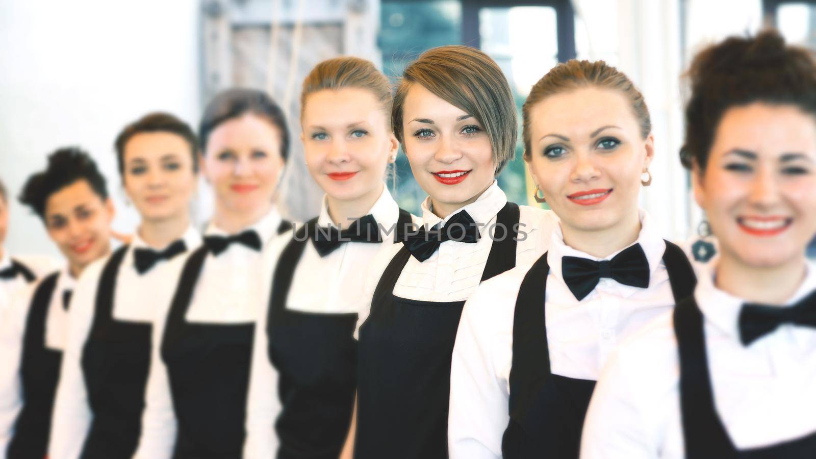 group of waiters at a prestigious restaurant standing in the column in the lobby of the restaurant