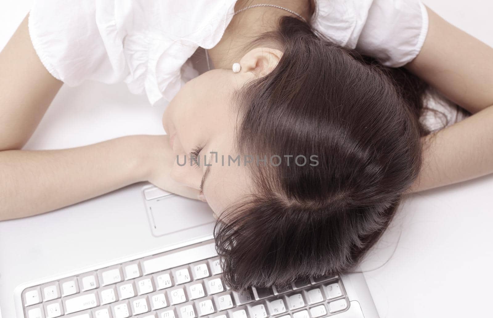 closeup.young business woman sleeping on the laptop keyboard .isolated on white