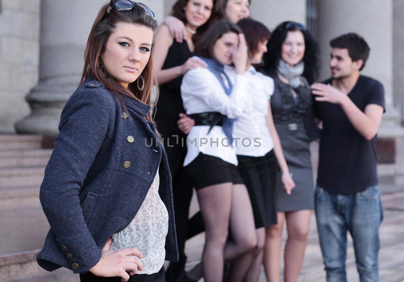 girl student on the background of the team of friends .photo with copy space