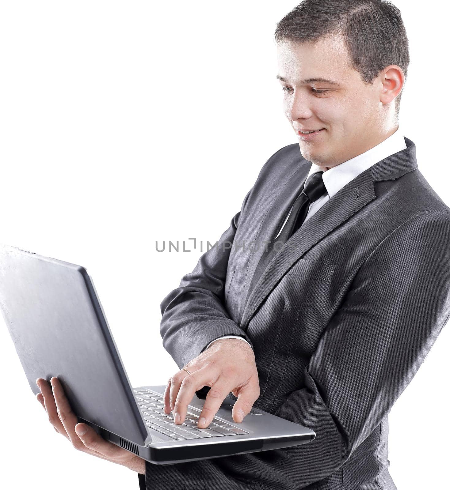 young businessman typing on laptop.isolated on white.