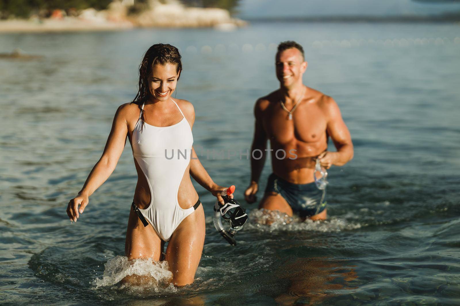 Couple Walking Through The Sea With Mask And Snorkel by MilanMarkovic78