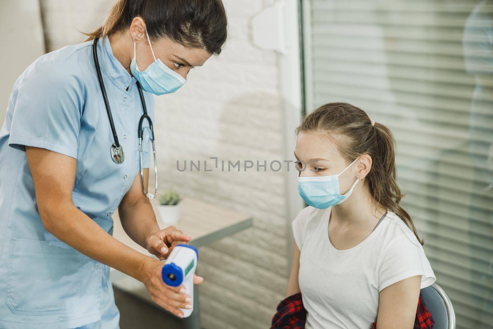 Teen Girl Having Her Temperature Checked Before Covic-19 Vaccine by MilanMarkovic78