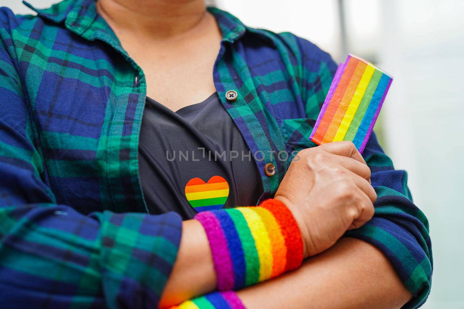 Asian woman with rainbow flag, LGBT symbol rights and gender equality, LGBT Pride Month in June.