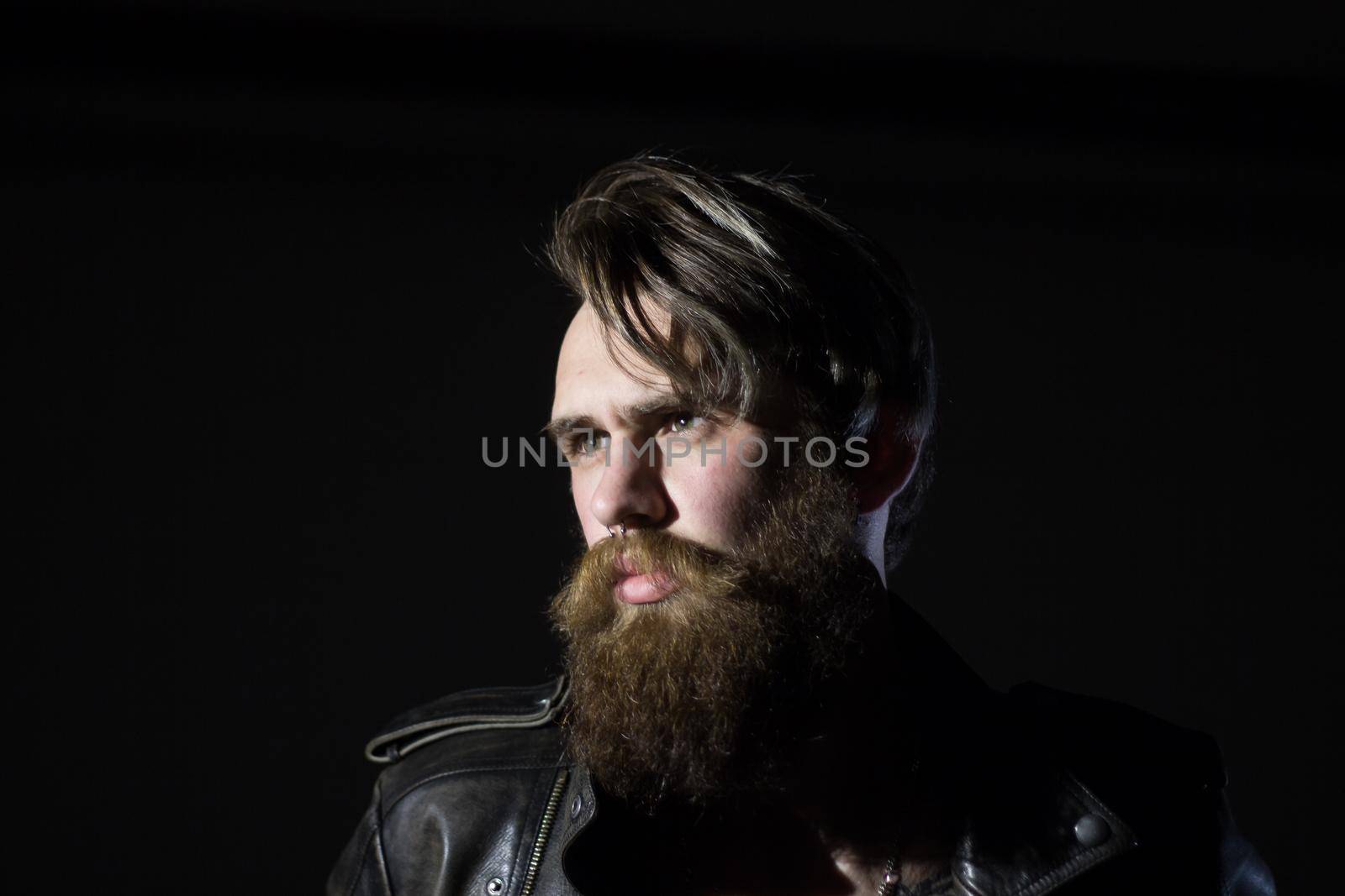 Brutal angry biker on a dark background.