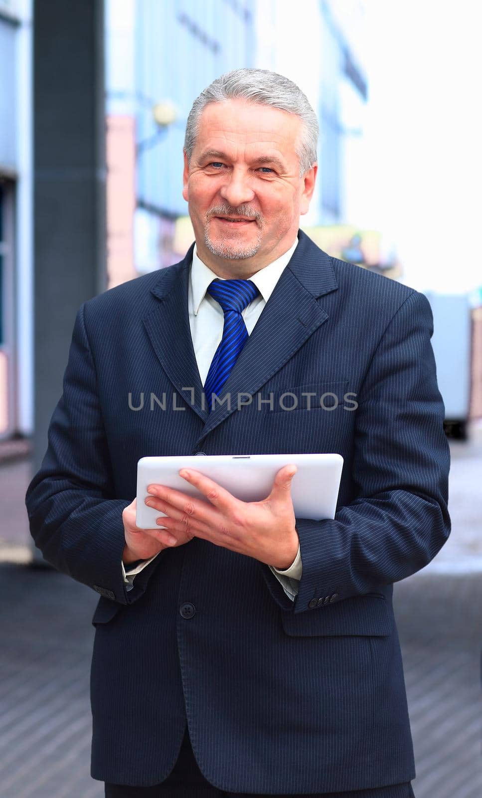 handsome businessman using tablet computer in modern office