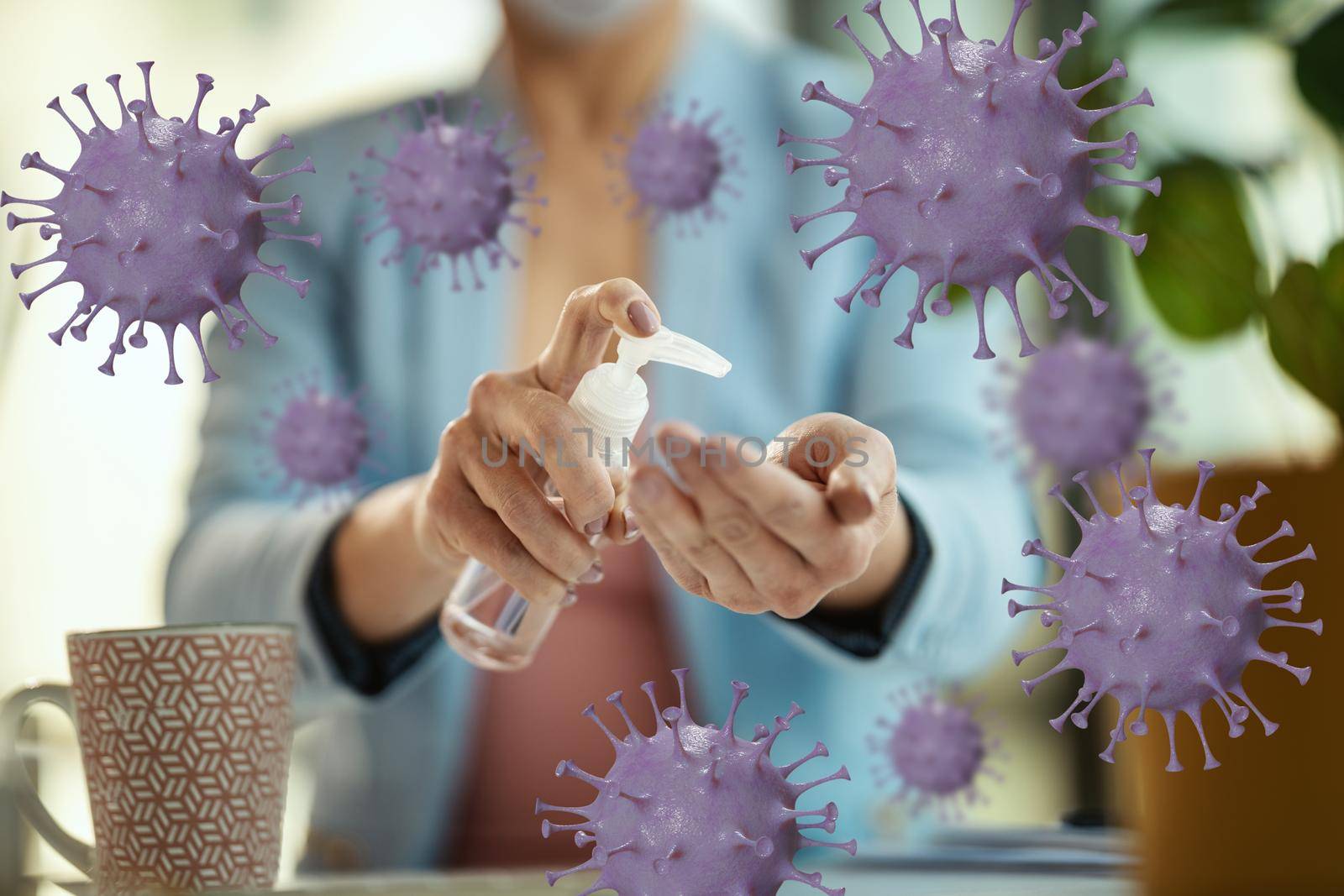 Close-up of a unrecognizable business woman uses antibacterial antiseptic gel for hands disinfection in a works place during self-isolation and quarantine to avoid infection during flu virus outbreak and coronavirus epidemic .