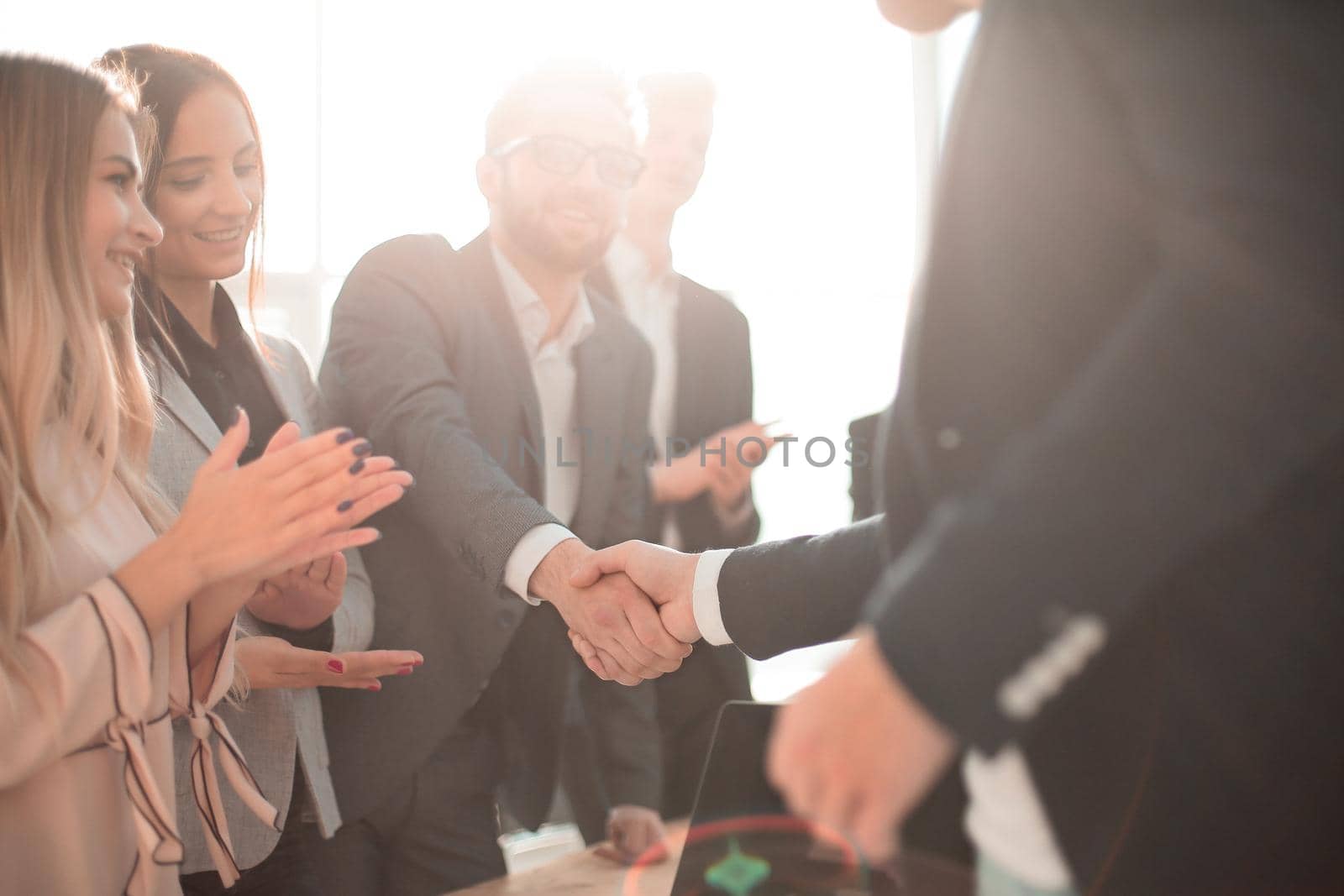 business partners shaking hands standing in the office. concept of partnership